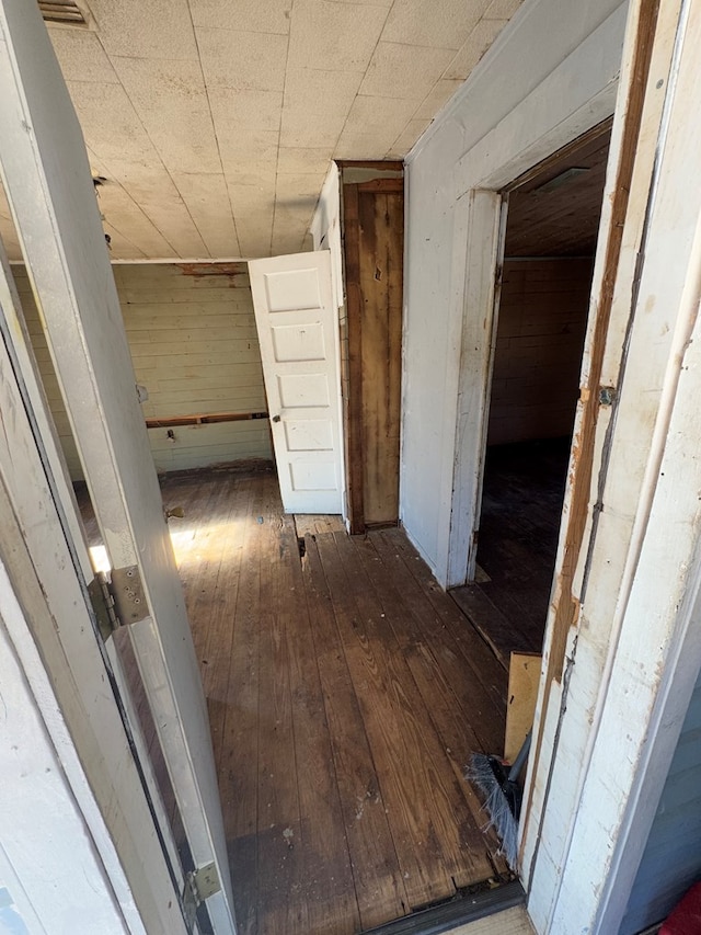 hallway with dark hardwood / wood-style flooring