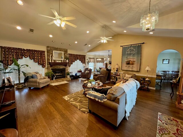 374 Smith Rd, Dothan, AL 36301 - living area with arched walkways, visible vents, a stone fireplace, and ceiling fan with notable chandelier