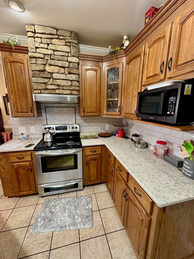374 Smith Rd, Dothan, AL 36301 - kitchen with exhaust hood, brown cabinets, tasteful backsplash, and stainless steel range with electric cooktop