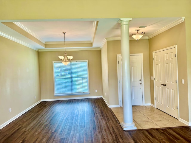 208 Planters Ct, Enterprise, AL 36330 - entrance foyer featuring wood finished floors, a chandelier, a tray ceiling, crown molding, and ornate columns
