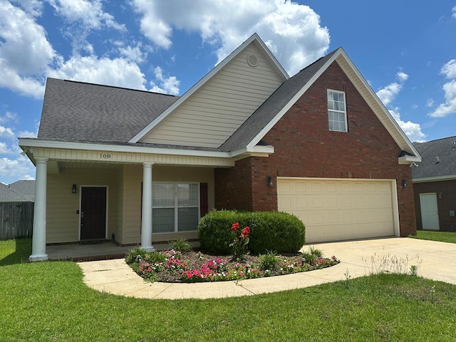 208 Planters Ct, Enterprise, AL 36330 - view of front of house with covered porch, driveway, a front yard, and brick siding