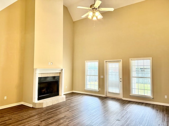 208 Planters Ct, Enterprise, AL 36330 - unfurnished living room featuring dark wood-style floors, a tiled fireplace, ceiling fan, and high vaulted ceiling