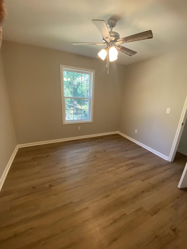 unfurnished room featuring ceiling fan and dark hardwood / wood-style flooring