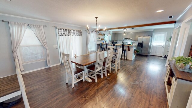 dining area with visible vents, baseboards, dark wood-style floors, ornamental molding, and a notable chandelier