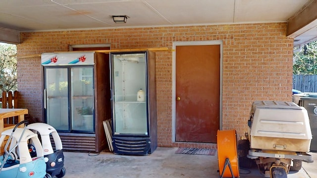 view of exterior entry with brick siding