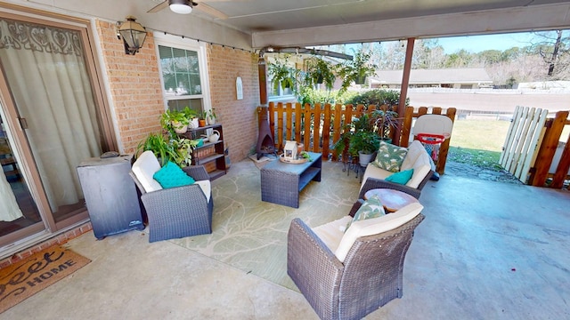 view of patio with ceiling fan, an outdoor hangout area, and fence