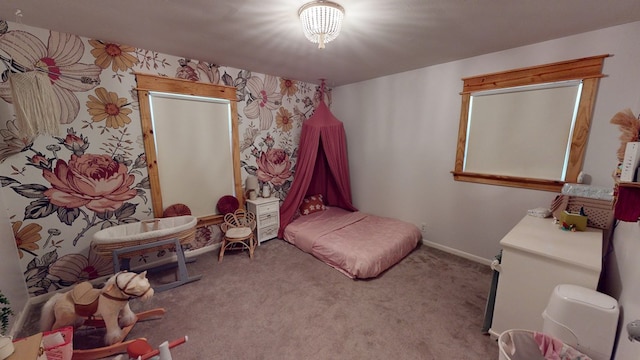 bedroom with carpet floors and baseboards