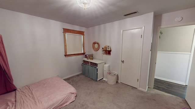 carpeted bedroom with visible vents and baseboards