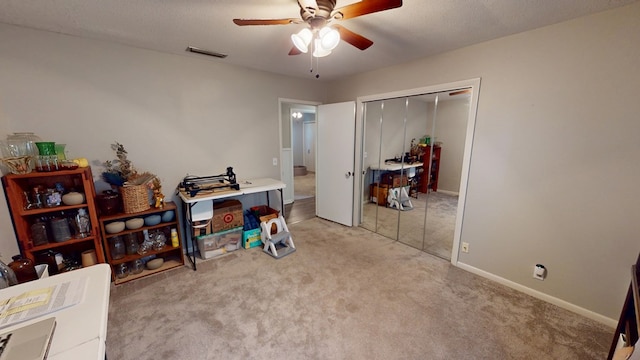 interior space with baseboards, visible vents, a ceiling fan, light colored carpet, and a textured ceiling