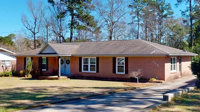 ranch-style house with a front lawn and brick siding