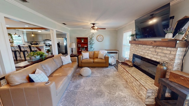 living area featuring ceiling fan, a fireplace, visible vents, and crown molding