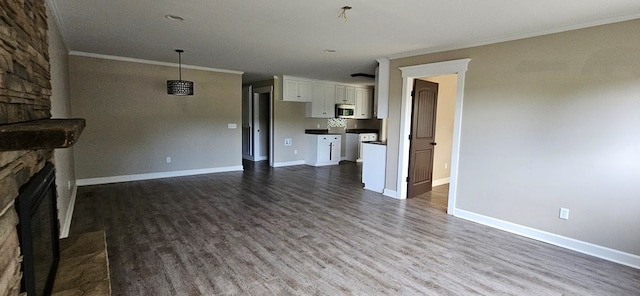 unfurnished living room with ornamental molding, a fireplace, and wood-type flooring