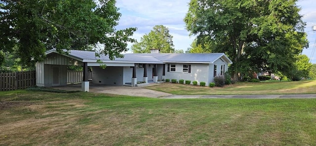 back of house featuring a carport and a yard