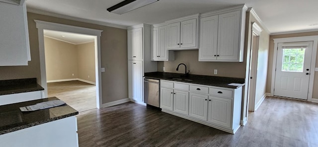 kitchen with sink, wood-type flooring, ornamental molding, white cabinets, and stainless steel dishwasher