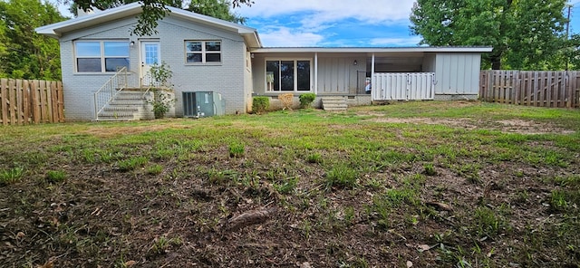 back of house with a yard and cooling unit