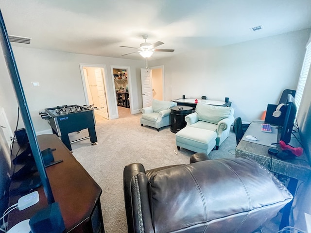 carpeted living room with a ceiling fan and visible vents