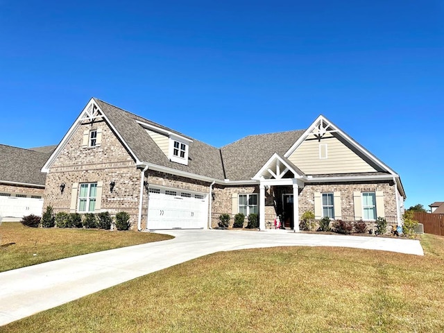 view of front of property with brick siding, a shingled roof, fence, driveway, and a front yard