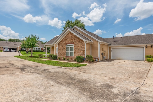 328 Hidden Creek Cir, Dothan, AL 36301 - ranch-style house featuring stone siding, concrete driveway, a garage, roof with shingles, and a front lawn