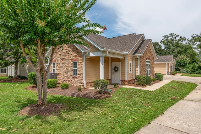328 Hidden Creek Cir, Dothan, AL 36301 - view of front facade with stone siding, a shingled roof, driveway, and a front yard