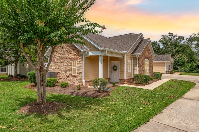 328 Hidden Creek Cir, Dothan, AL 36301 - view of front facade with stone siding, roof with shingles, concrete driveway, a lawn, and an attached garage