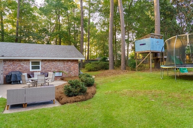 view of yard featuring a patio area and a trampoline