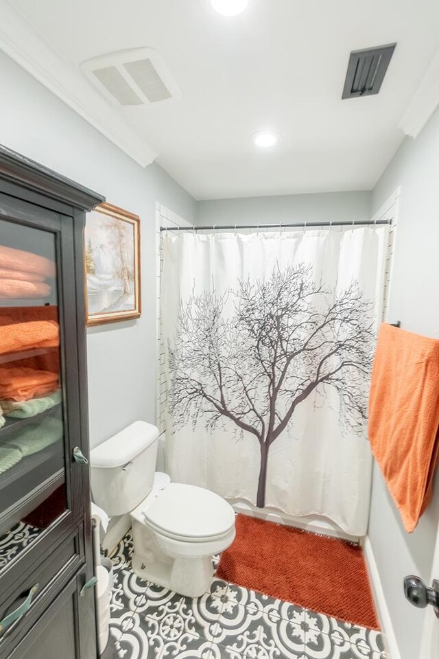 bathroom with tile patterned floors, walk in shower, ornamental molding, and toilet