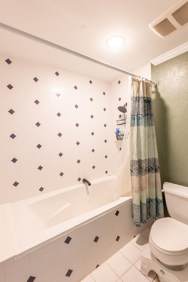 bathroom featuring tile patterned floors, shower / bath combo with shower curtain, and toilet