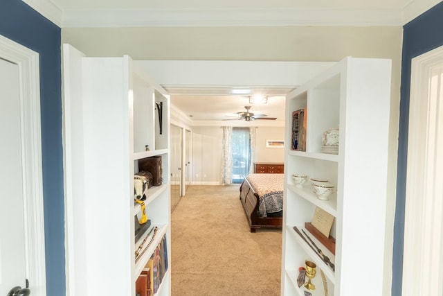 carpeted bedroom featuring ceiling fan and crown molding