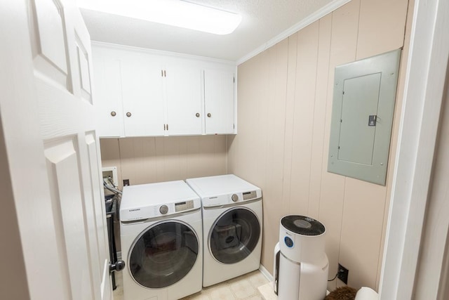 laundry room with independent washer and dryer, electric panel, cabinets, and ornamental molding