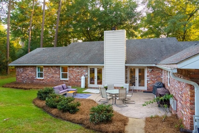 back of house with a yard, an outdoor living space, french doors, and a patio