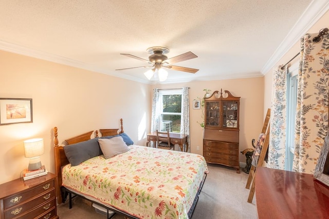 bedroom featuring ceiling fan, carpet, a textured ceiling, and ornamental molding