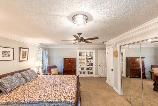 carpeted bedroom featuring ceiling fan, ornamental molding, and a textured ceiling