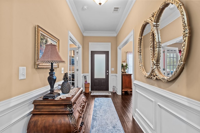 foyer featuring ornamental molding and dark hardwood / wood-style floors