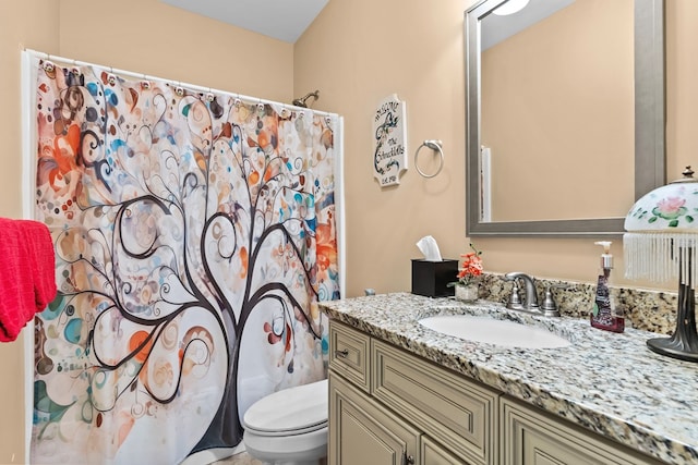 bathroom featuring toilet, a shower with curtain, and vanity