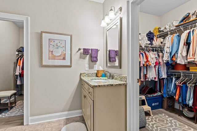 bathroom featuring tile patterned flooring and vanity