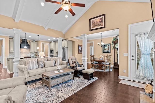 living room featuring beam ceiling, dark hardwood / wood-style floors, ceiling fan with notable chandelier, and ornate columns