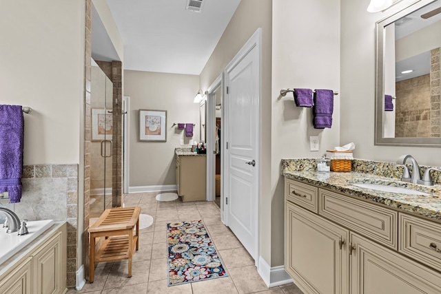 bathroom featuring vanity, shower with separate bathtub, and tile patterned flooring