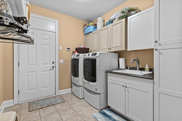 washroom featuring sink, cabinets, separate washer and dryer, and light tile patterned flooring