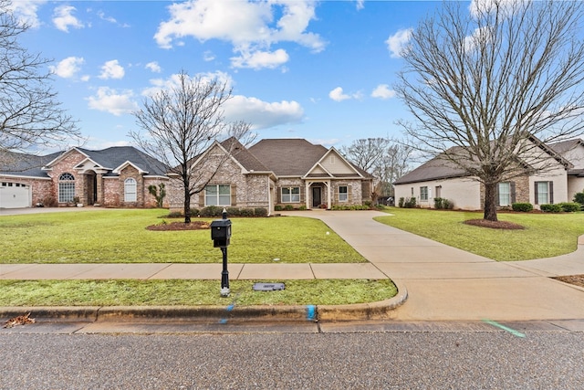 view of front of house featuring a front yard and a garage