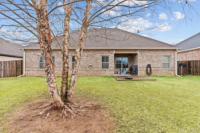 rear view of property with a patio and a lawn