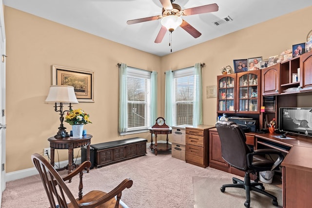 office space featuring ceiling fan and light carpet