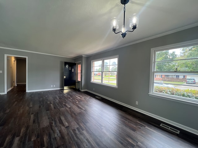 interior space with dark hardwood / wood-style floors, an inviting chandelier, and ornamental molding