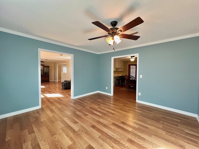 unfurnished room with crown molding, ceiling fan, and light wood-type flooring