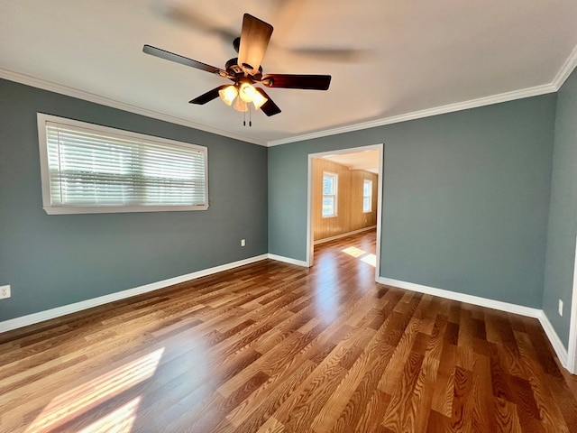 unfurnished room featuring crown molding, wood-type flooring, and ceiling fan