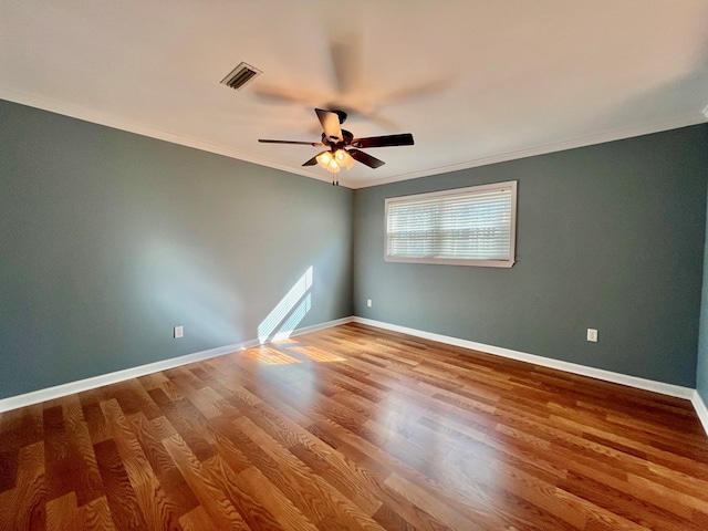 spare room featuring hardwood / wood-style floors, crown molding, and ceiling fan