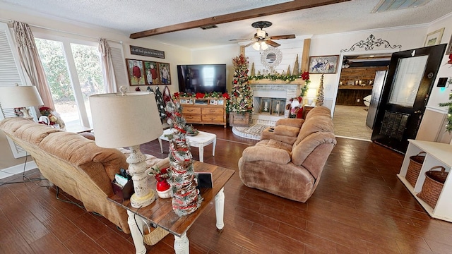 living room featuring dark hardwood / wood-style flooring, crown molding, and a textured ceiling