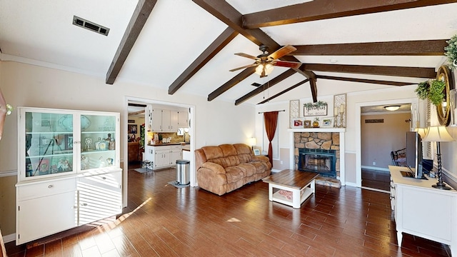 living room with ceiling fan, dark hardwood / wood-style floors, vaulted ceiling with beams, and a fireplace