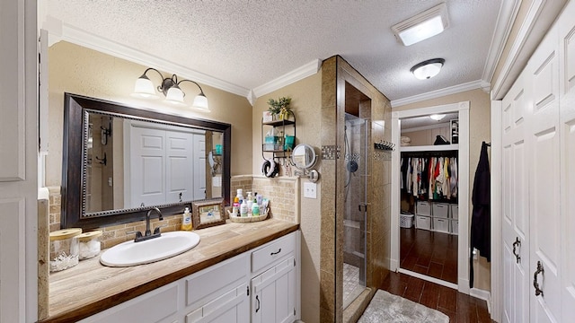 bathroom featuring vanity, hardwood / wood-style floors, ornamental molding, and a shower