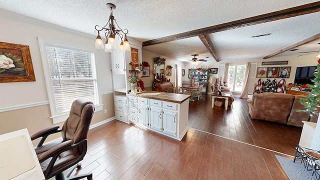 office space with crown molding, dark wood-type flooring, a textured ceiling, ceiling fan with notable chandelier, and beamed ceiling