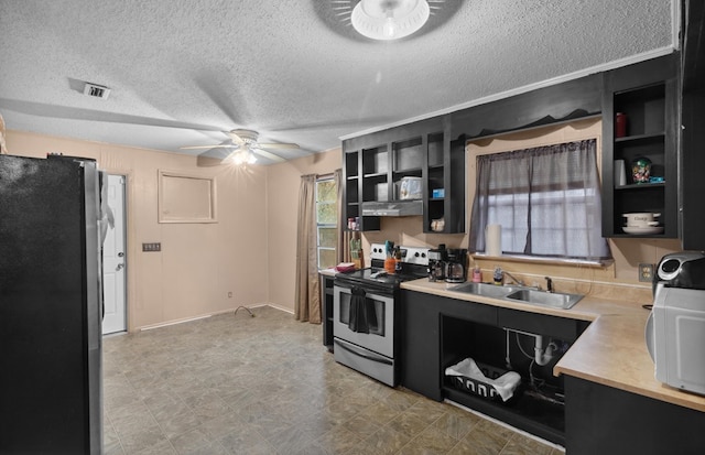 kitchen featuring appliances with stainless steel finishes, a textured ceiling, ceiling fan, and sink